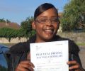 Patrice with Driving test pass certificate